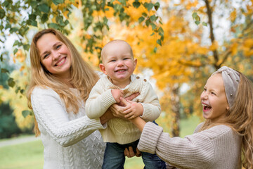 Happy family on autumn park. Mother and daughter walking in the Park