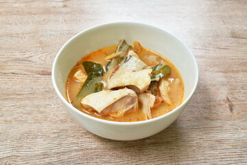 boiled salmon fish in spicy tom yum soup on bowl