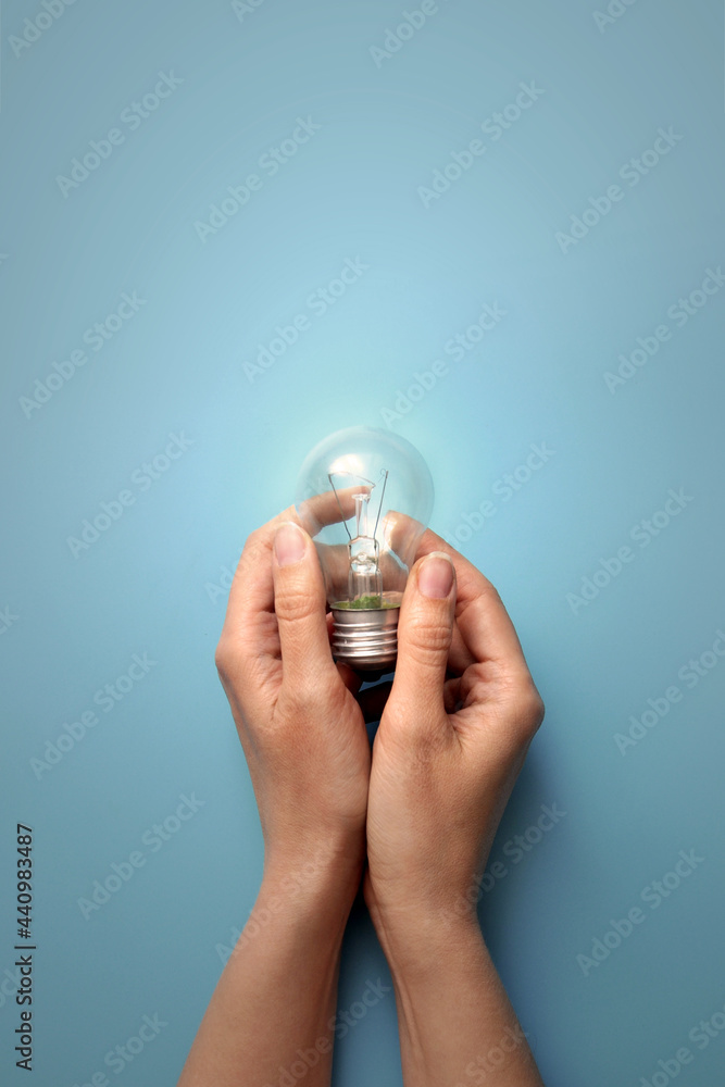 Poster a burning lamp in the hands of a man. the emergence of a creative idea for solving a complex problem