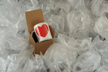 white mug in a cardboard box on a light background