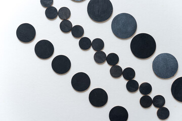 round wooden shapes hand painted - arranged in a loose composition on a light ground - photographed in a top-down orientation