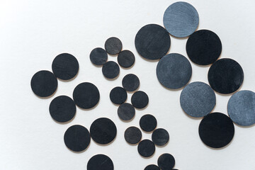 round wooden shapes hand painted - arranged in a loose composition on a light ground - photographed in a top-down orientation