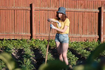 Young caucasian woman female farmer working in the agriculture filed