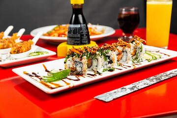 Obraz na płótnie Canvas Delicious Sushi Seafood Hot Roll Sashimi Niguiri Tuna Salmon Fish Dish On a Red Table