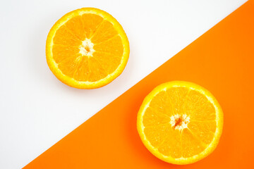 Close up photo of Orange Fruit on the white and orange background. Citrus cut in half, inside,...