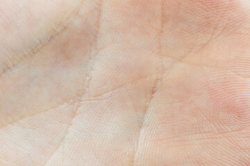 Human palm skin texture background. Macro photo, close up. Palmistry concept.