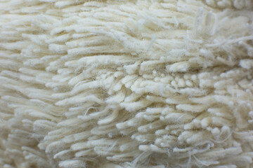 White cotton towel or carpet.fluffy texture background. Close up, macro photo. Soft focus image.