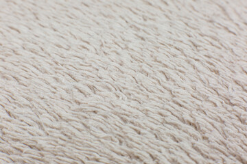 Beige cotton towel or carpet.fluffy texture background. Close up, macro photo. Soft focus image.