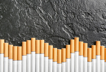 Many cigarettes on dark background, closeup
