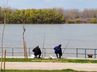 fishermen on the Danube embankment on a sunny day