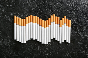 Many cigarettes on dark background
