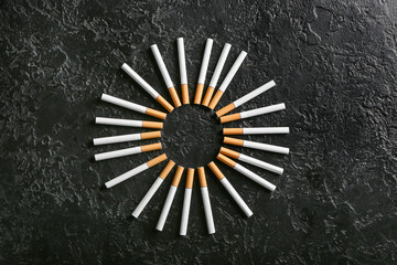 Frame made of cigarettes on dark background
