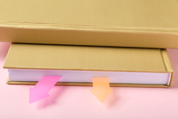 Books with bookmarks on color background, closeup