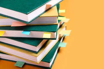 Books with bookmarks on color background, closeup