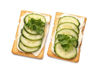 Tasty crackers with cheese and cucumber on white background