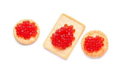 Tasty crackers with red caviar on white background