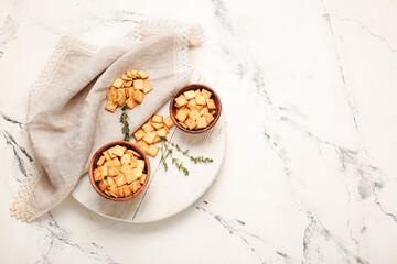 Composition with tasty crackers on light background