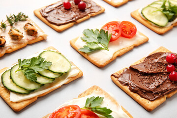 Different crackers on grey background, closeup