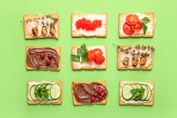 Different crackers on color background