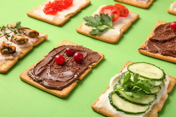 Different crackers on color background, closeup