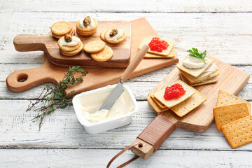 Fototapeta na wymiar Composition with tasty crackers, cheese and seafood on light wooden background