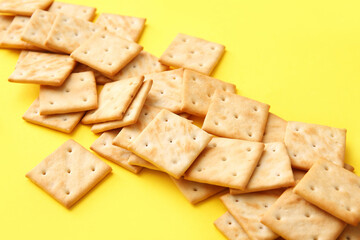 Tasty crackers on color background, closeup