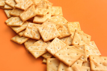 Tasty crackers on color background, closeup