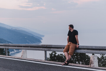 man at the cliff sea on background