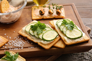 Composition with tasty crackers on wooden background, closeup