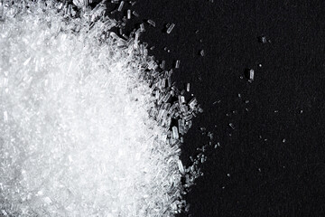 Monosodium glutamate or seasoning powder on black background and copy space. selective focus