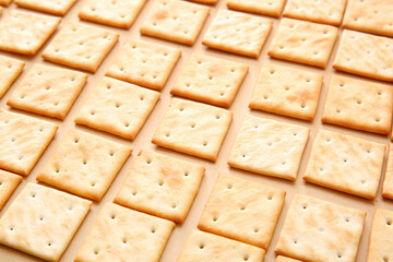 Tasty crackers on color background, closeup