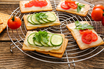 Different crackers on wooden background, closeup