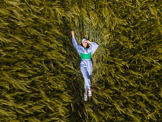 smiling woman laying down in wheat field