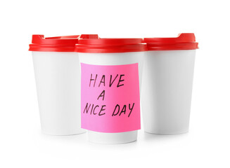 Takeaway cups for coffee and sticker note with text HAVE A NICE DAY on white background