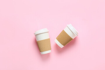 Takeaway cups for coffee on color background