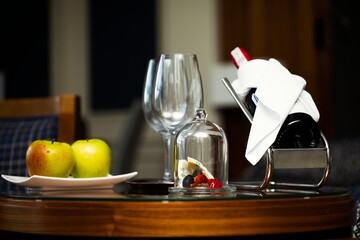 Honeymoon celebration with wine tasting and  food pairing. Luxurious bottle of wine on the wine stand and gourmet food.