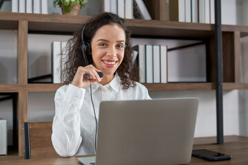 Customer support phone operator working at computer. Happy call center agent working on support...