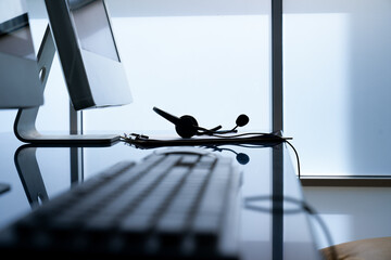 VOIP headset on table and  computer keyboard concept for customer support communication