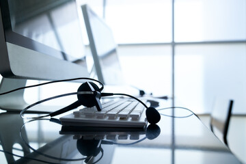 VOIP Headset on computer keyboard and desk for call center to support customer , IT helpdesk service