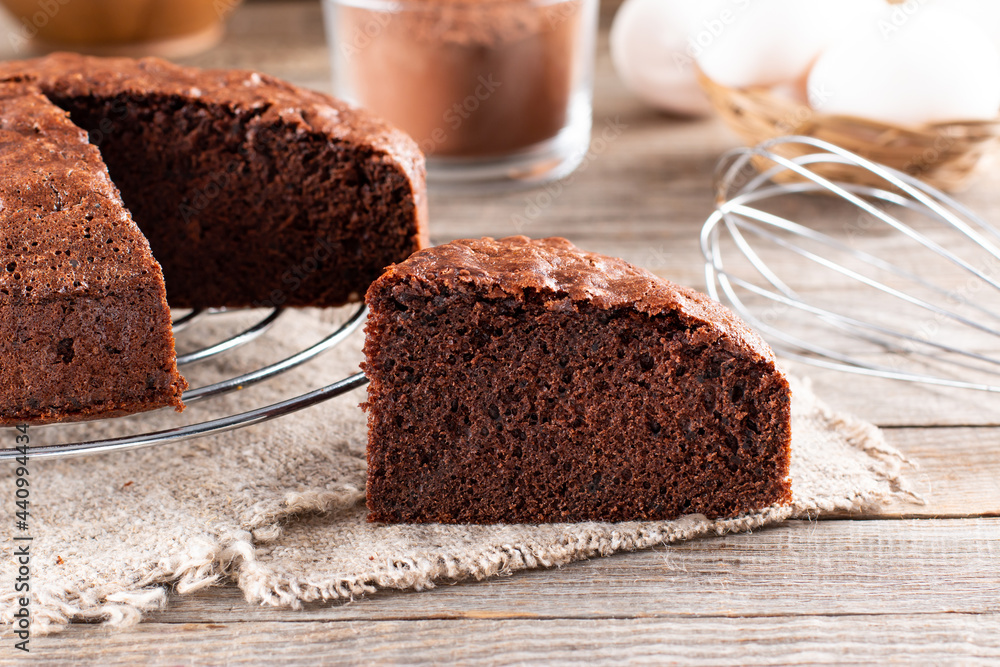 Wall mural Piece of delicious fresh homemade chocolate sponge cake on table