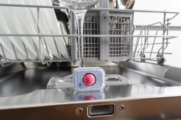 Wine glass in dishwasher machine and dishwasher detergent tablet