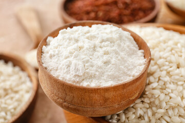 Fototapeta na wymiar Different types of raw rice and flour on color background, closeup