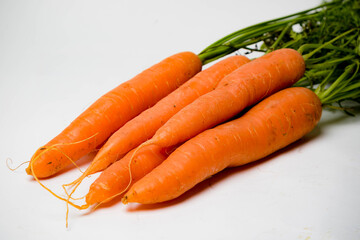 A bunch of carrots with tops, isolated on a white background
