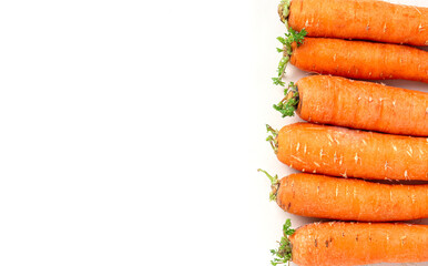 Fresh organic carrots on a white background top view. Natural vegetables concept.