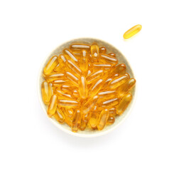 Bowl with fish oil capsules on white background