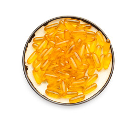 Plate with fish oil capsules on white background
