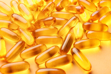 Fish oil capsules on color background, closeup