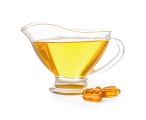 Gravy-boat of fish oil and capsules on white background