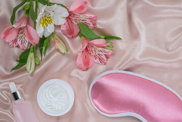 Night face care routine concept. top view pink sleeping mask, moisturizer cream, serum lotion