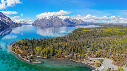 Aerial view of Kathleen Lake in northern Canada, Haines Junction, Yukon Territory on a perfect blue sky day. Taken in June with boreal forest surrounding the stunning lake below. 